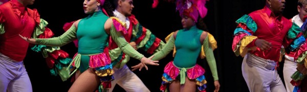 Latinos in colorful clothes dancing