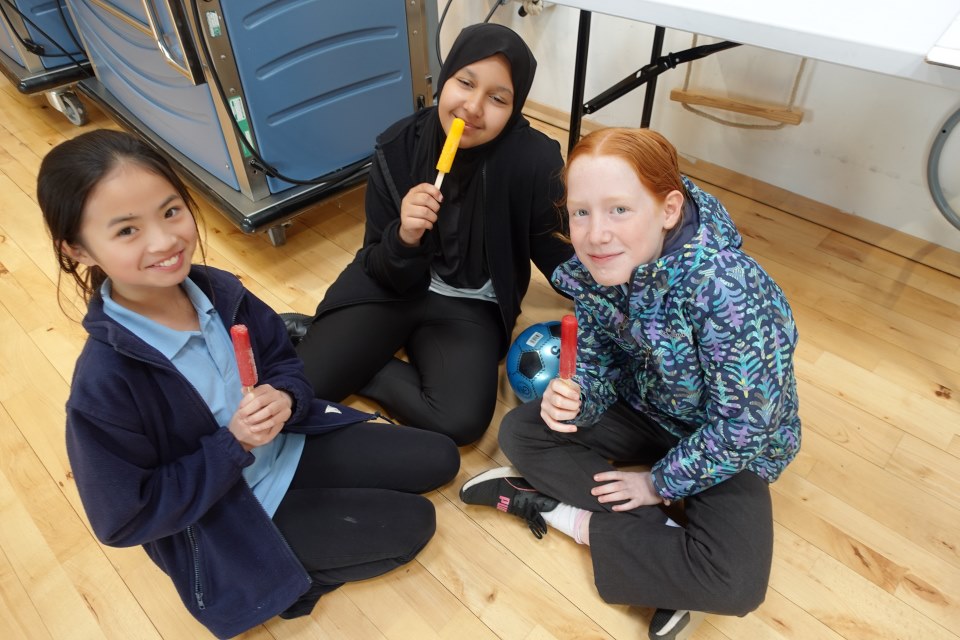 A group of Year 6 children enjoying some lolly pops after finishing SATs