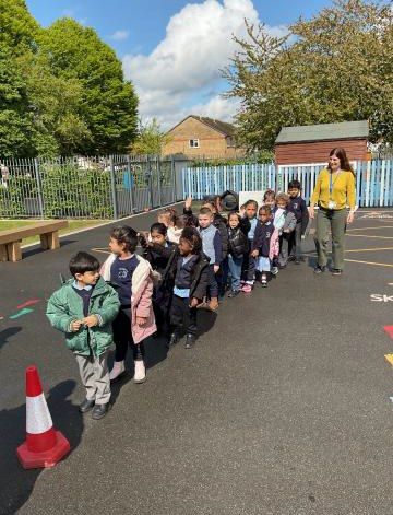 Nursey children lining up to see the fire engine
