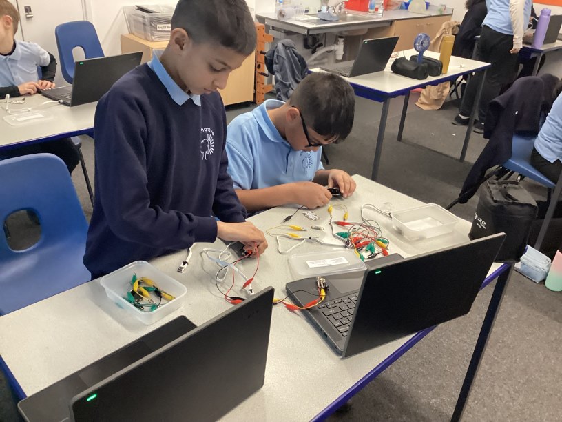 Year 5 children working on programming and coding using micro controllers