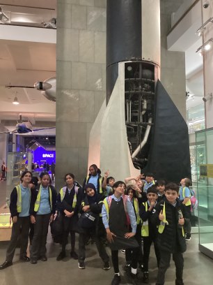 Some year 5 children next to a rocket booster