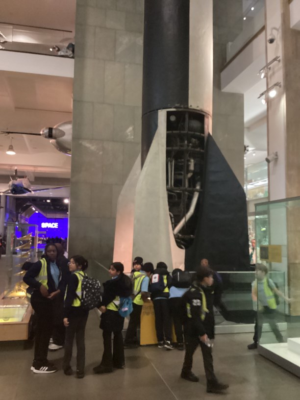 Some year 5 children next to a rocket booster