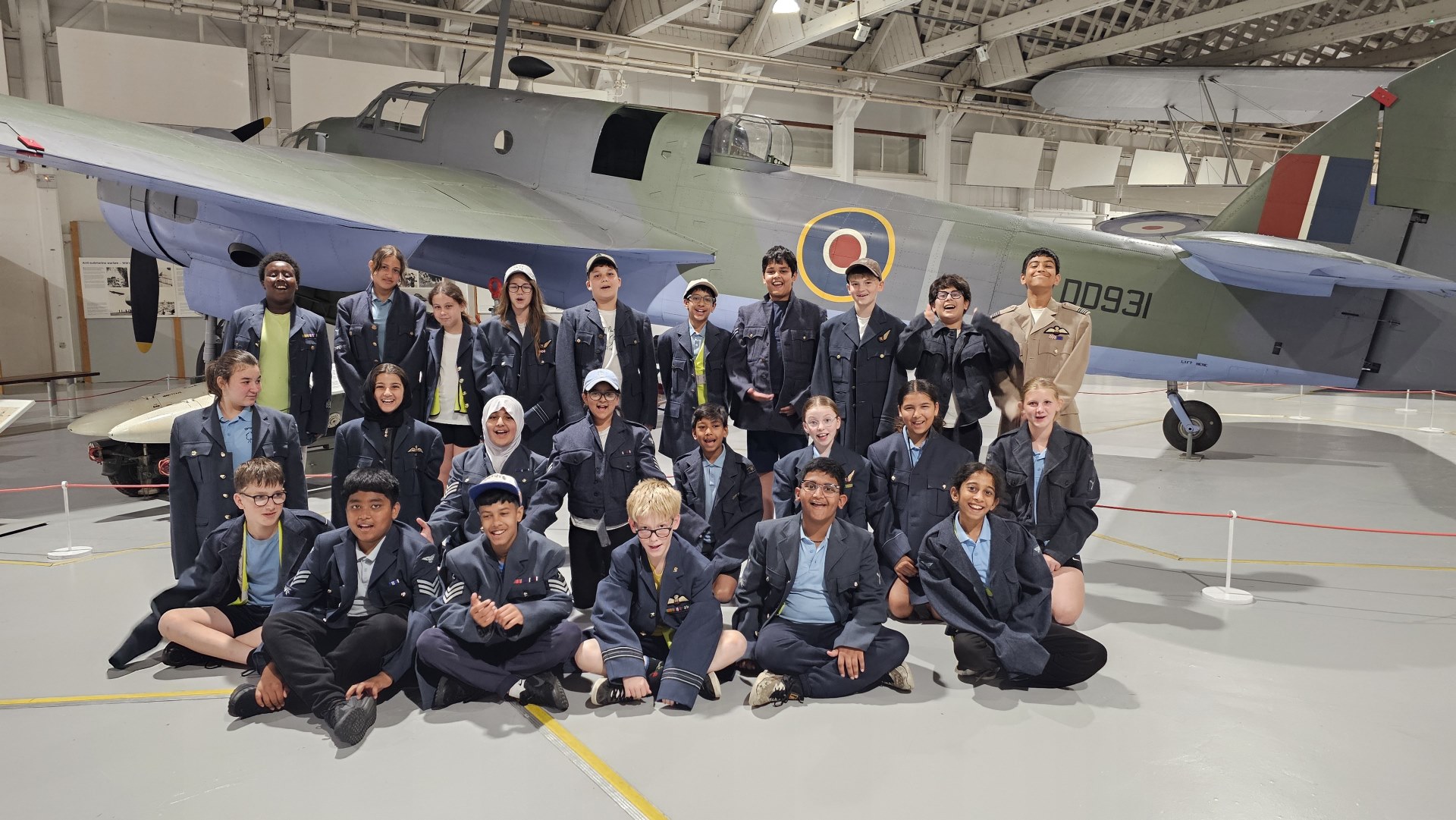 Year 6 dressed as pilots in front of a plane